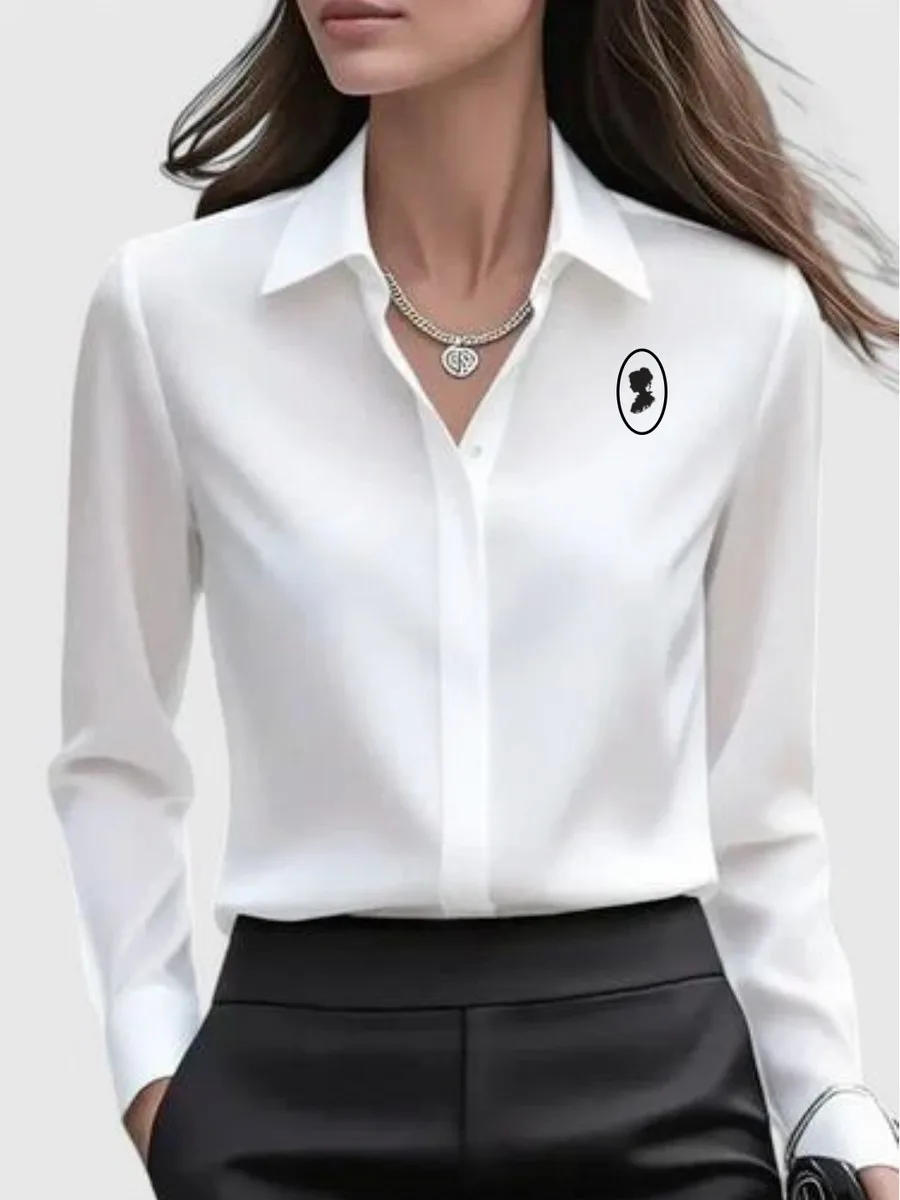 Woman wearing the white Bonacieux silk shirt with the framed cameo embroidered over the heart
